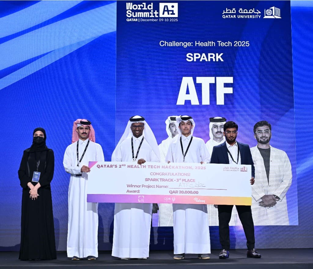 ATF team on stage at World Summit AI Qatar holding the Health Tech Hackathon award check