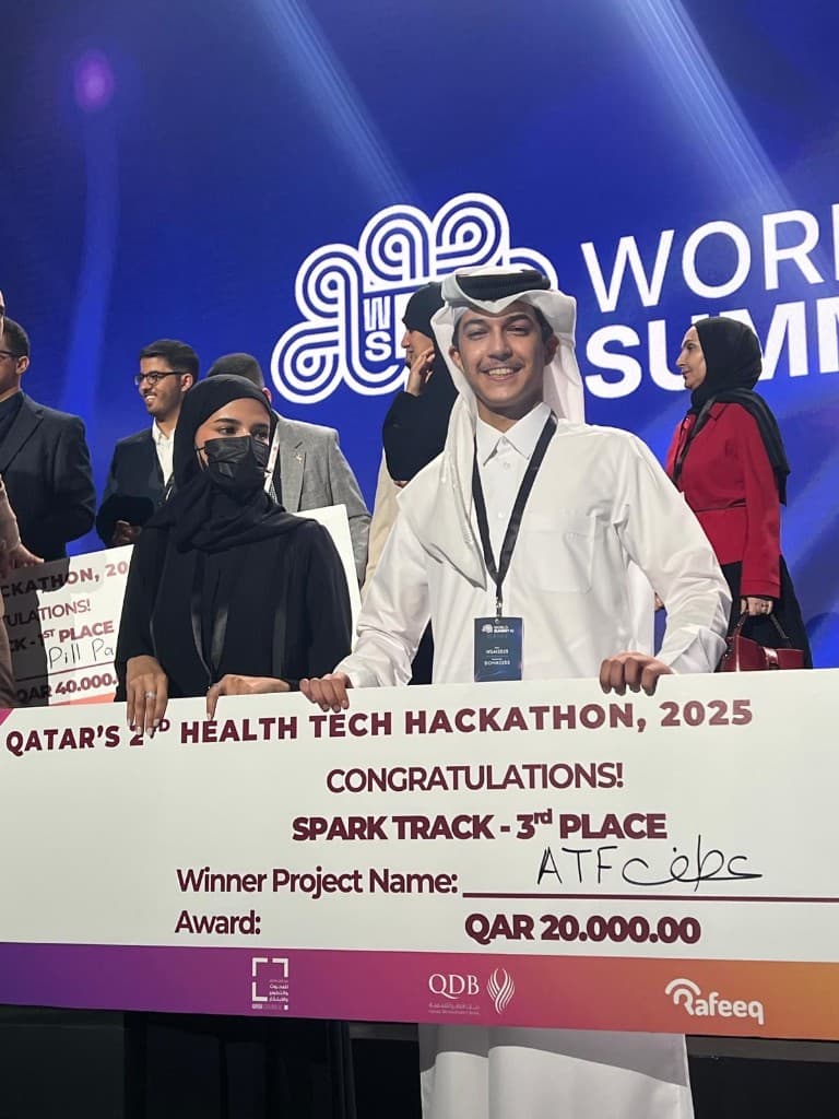 ATF عطف — ceremonial prize check for third place, Qatar Health Tech Hackathon 2025